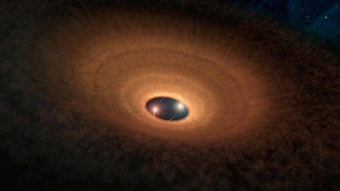 Künstlerische Darstellung der Materiescheibe um die beiden Zentralsterne des Systems YLW 16A. Alle 93 Tage kommt es zu einem Aufblinken des Systems. (NASA / JPL-Caltech) Künstlerische Darstellung der Materiescheibe um die beiden Zentralsterne des Systems YLW 16A. Alle 93 Tage kommt es zu einem Aufblinken des Systems. (NASA / JPL-Caltech)
