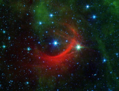 Der rote Bogen auf diesem Infrarotbild des Spitzer Space Telescope ist eine gigantische Schockwelle, die von einem schnellen Stern namens Kappa Cassiopeiae erzeugt wird. (NASA / JPL-Caltech) Der rote Bogen auf diesem Infrarotbild des Spitzer Space Telescope ist eine gigantische Schockwelle, die von einem schnellen Stern namens Kappa Cassiopeiae erzeugt wird. (NASA / JPL-Caltech)
