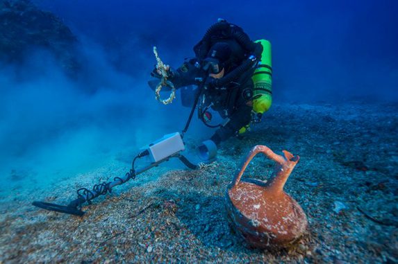Der griechische Taucher Alexandros Sotiriou entdeckt einen intakten Keramikkrug und einen Takelagenring aus Bronze. (Brett Seymour, Copyright: Return to Antikythera 2014) Der griechische Taucher Alexandros Sotiriou entdeckt einen intakten Keramikkrug und einen Takelagenring aus Bronze. (Brett Seymour, Copyright: Return to Antikythera 2014)