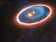 Künstlerische Darstellung der Gas- und Staubstrukturen um das Doppelsternsystem GG Tau-A. Forscher haben in der Region zwischen den beiden Scheiben Gasknoten registriert. Die äußere Scheibe versorgt die innere mit Materie, wodurch die Entstehung von Planeten möglich wäre. (ESO / L.Calçada, ALMA (ESO / NAOJ / NRAO))