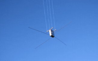 Der CubeSat Juventas beim Antennentest an einer Drohne hängend. (Credits: ESA)
